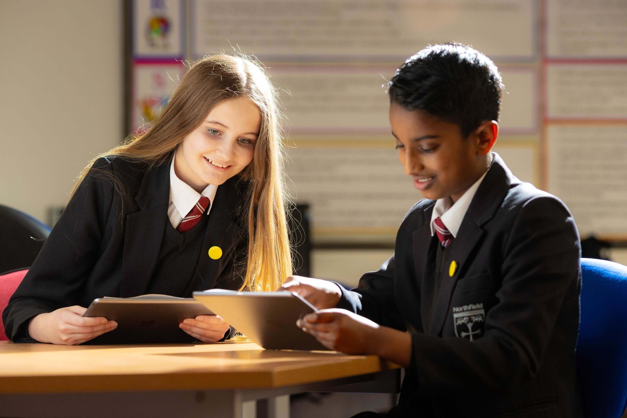 2 students from Northfield school using iPads in a classroom