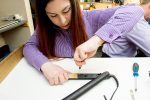 A SimplyFixIt technician fixing a set of GHD hair straighteners.
