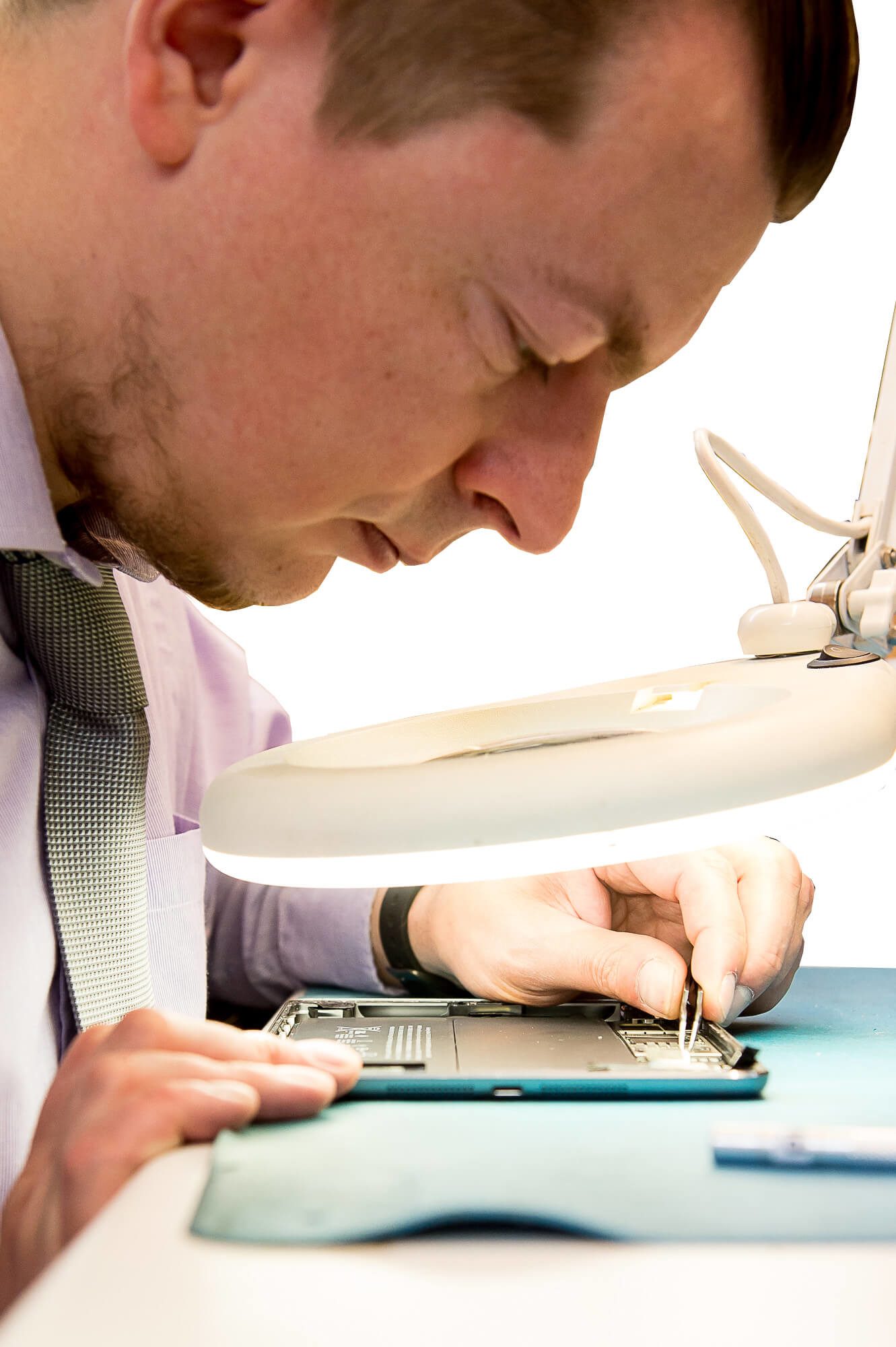 One of our technicians fixing an Apple iPad