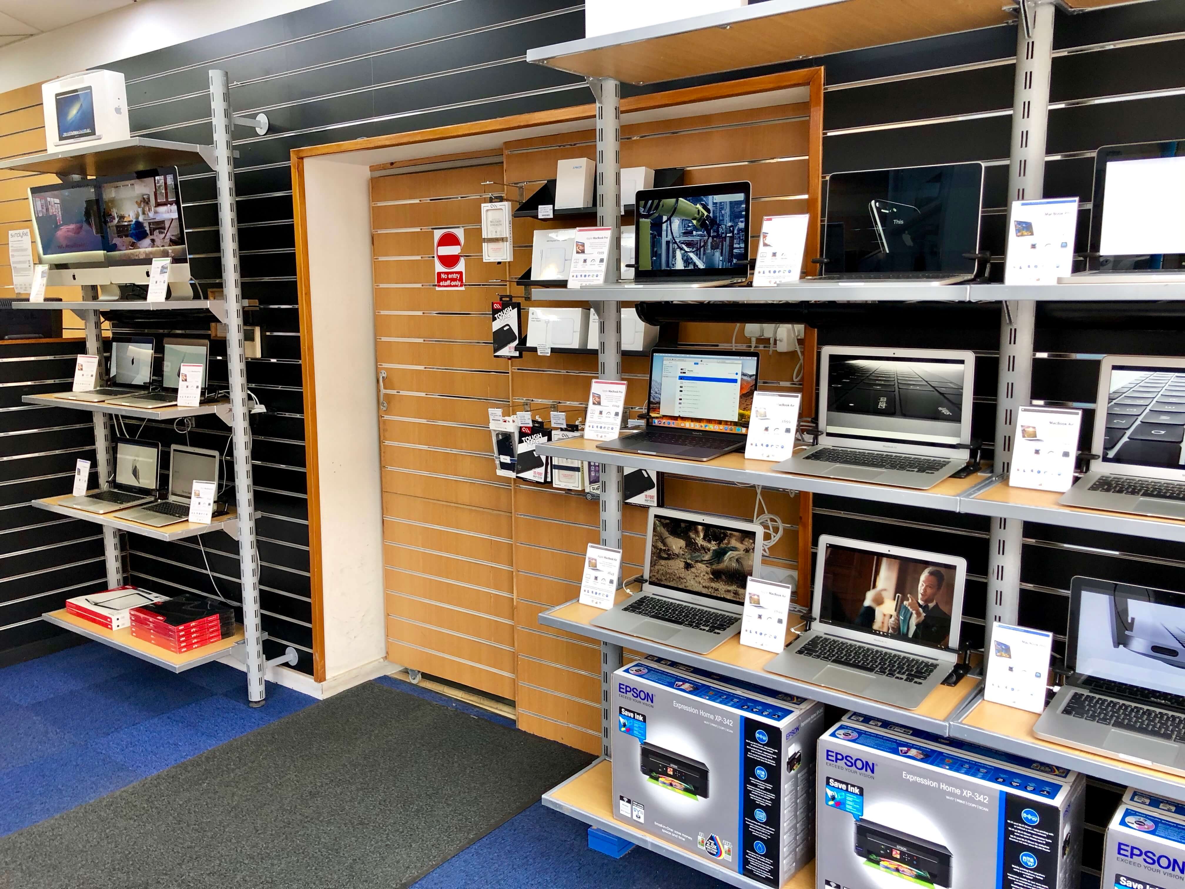 Shelves in SimplyFixIt at Forrest Road, which have certified refurbished Macs on them.